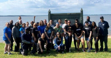 Wyndham Destinations employee volunteers from Club Wyndham resorts in Williamsburg, Va., celebrate cleaning up the banks of the James River