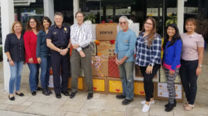 City of South Miami officials and Interval International employees celebrate the company’s 23rd annual Thanksgiving Food Drive.