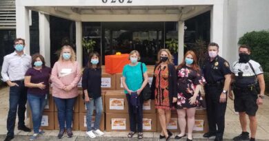 Interval International employees present City of South Miami officials with 50 boxes filled with items for Thanksgiving meals.