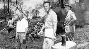 Arnold working on a stump which was later carved into a sculpture of Deke.