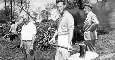 Arnold working on a stump which was later carved into a sculpture of Deke.