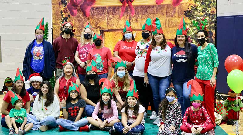 Interval International employees volunteer to distribute toys, during the company’s 28th annual Holiday Toy Fest at the Gibson Bethel Community Center in South Miami.