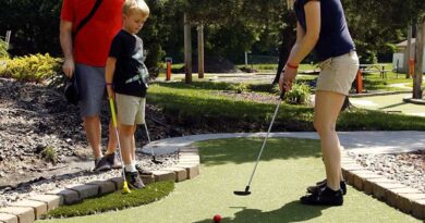 Dad and son watch mom putt at one of the new mini golf holes at Veterans Memorial Park in Richfield, Minnesota. Wheel Fun Rentals, operators of the course, engaged Adventure Golf & Sports (AGS) to renovate the mini golf course using their timesaving, economical and eco-friendly Modular Advantage® Mini-Golf system.