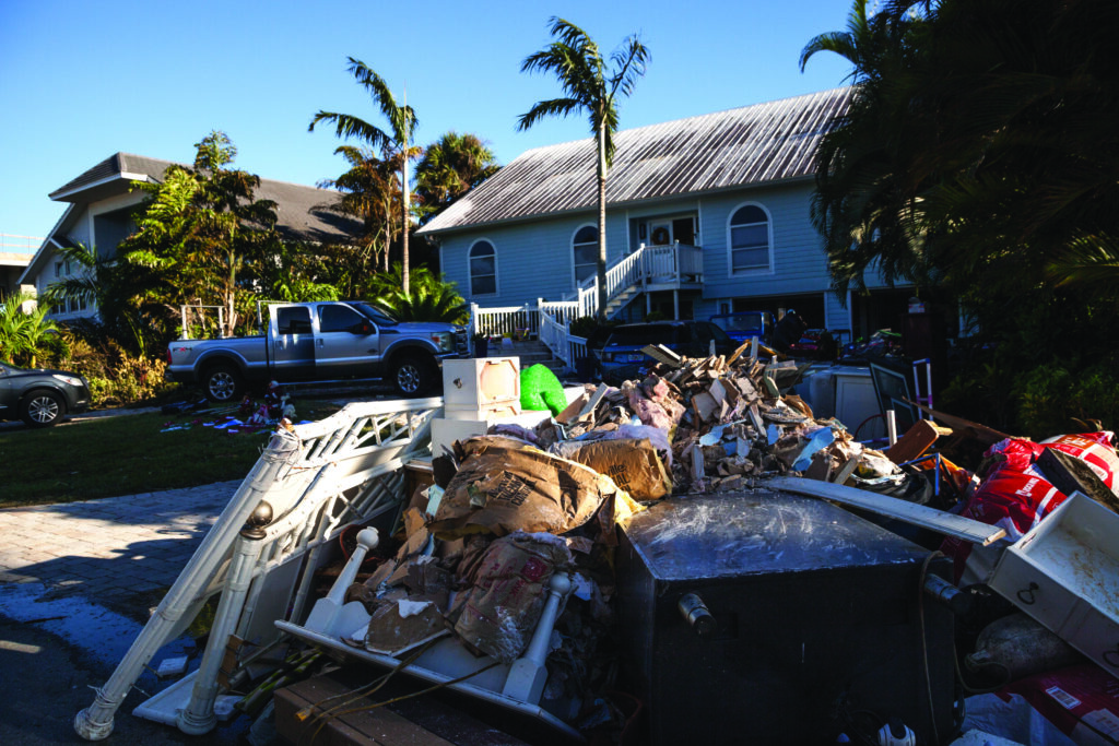 Naples, Florida, USA - September 28, 2022: NEWS  Debris including personal items alongside flooded homes after Hurricane Ian in Naples, Florida. Editorial only