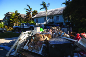Naples, Florida, USA - September 28, 2022: NEWS Debris including personal items alongside flooded homes after Hurricane Ian in Naples, Florida. Editorial only